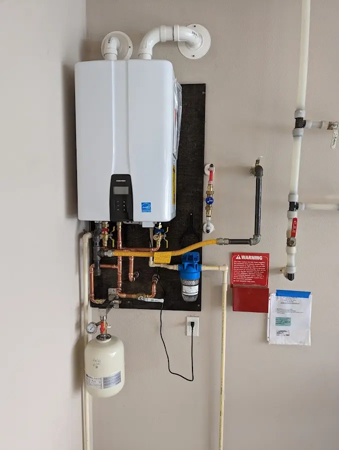 Professional plumber installing copper piping in a Merrimac home